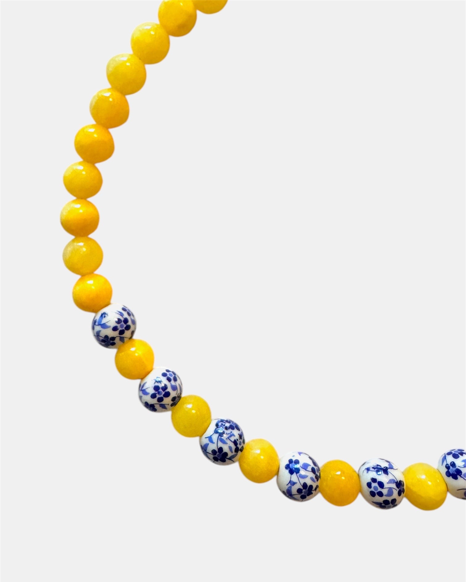 Yellow beaded necklace featuring ceramic accents for a cheerful and stylish look