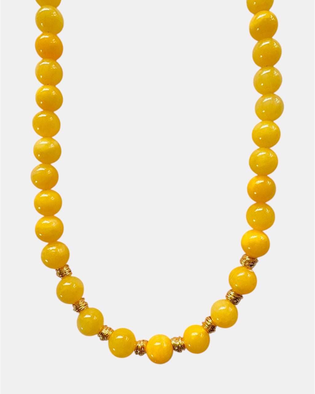Yellow beaded necklace on a white background