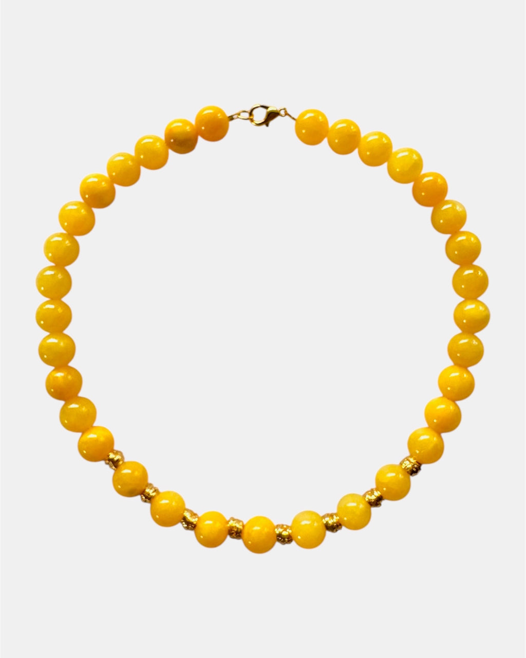 Yellow beaded necklace on a white background